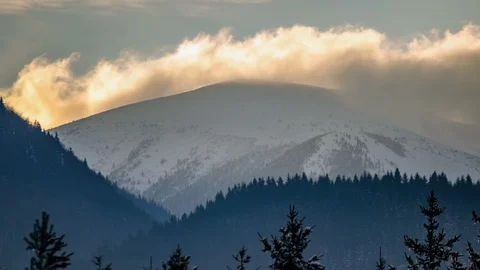 Clouds moving over snowy peak in winter mountains nature Time lapse Stock-Footage 107864003