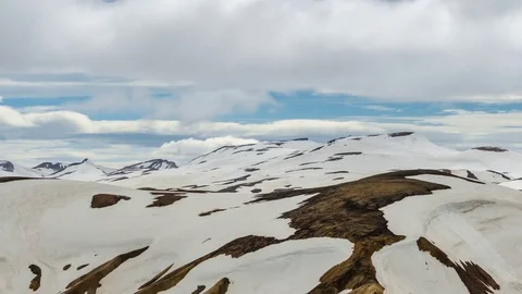 Clouds moving over snowy rainbow mountains in Iceland. Time lapse pan Stock Footage 83395060