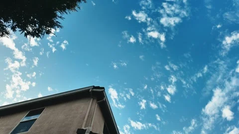 Clouds moving over top of track house motion lapse Stock Footage 257930897
