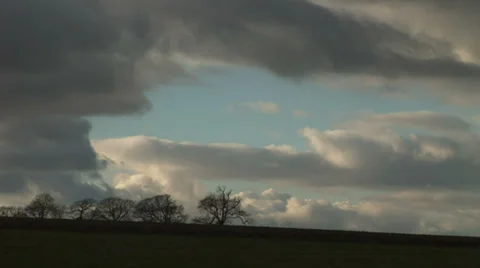 Clouds moving over trees , winter in England Video stock 34160369