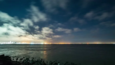 Clouds moving over water as planes take off in the distance Stock Footage 154918553