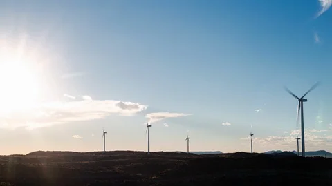 Clouds moving over wind turbines in an open field Stock Footage 101680841