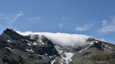 Clouds moving in the peaks of Alps mountain range Stock Footage 111942753