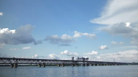 The clouds moving quickly on the blue sky near to bridge in the slide Stock Footage 62906734