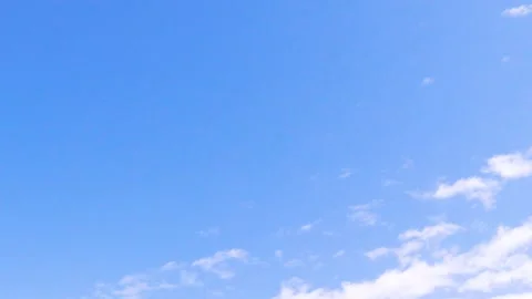 Clouds moving on revealing bright blue sky timelapse daytime. Cumulus wind trave Stock Footage 247448704