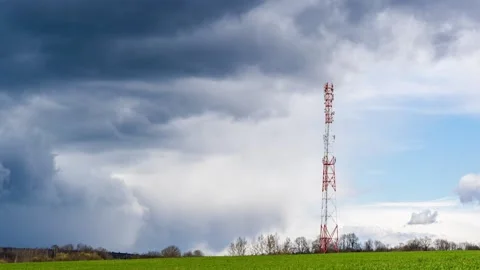 Clouds moving in sky above telecommunications tower Stock Footage 153223300
