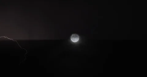 Clouds moving in the stormy sky with lightning flashing, thunder and full moo Stock Footage 123362425