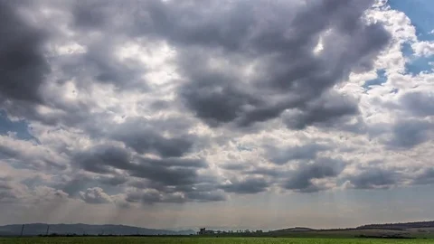 Clouds moving with sunbeams above the hills Stock Footage 75576155