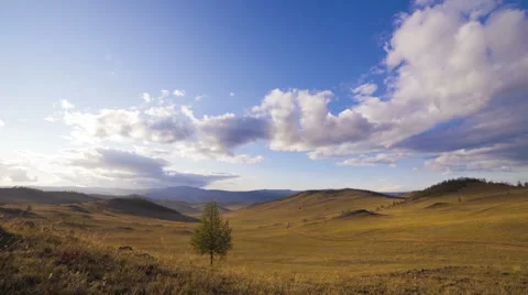 Clouds moving sunlights on hill Stock Footage 47084589