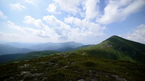 Clouds Moving Through The Sky Over Green Mountain Top Video stock 84117426
