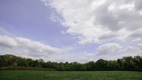 Clouds Moving Through The Sky Over Green Field Video stock 84120514