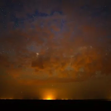 Clouds at night against the background of bright stars in the sky after sunse Foto stock