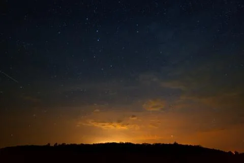 Clouds at night against the background of bright stars in the sky after sunse Foto stock