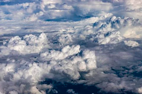 Clouds outside the airplane window. White clouds, View of the sky above the c Stock Photos