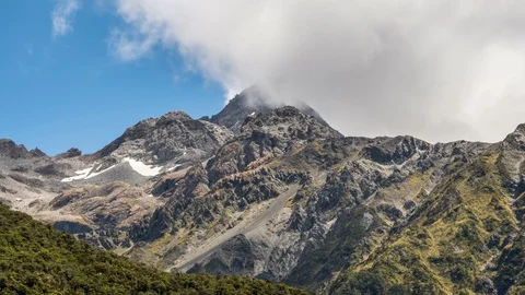 Clouds over alpine mountain peak in New Zealand south alps landscape Time lapse Stock Footage 117292397