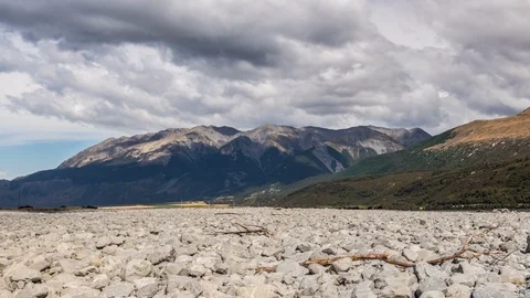 Clouds over alpine mountains and river channel in New Zealand nature Time lapse Stock Footage 117233860