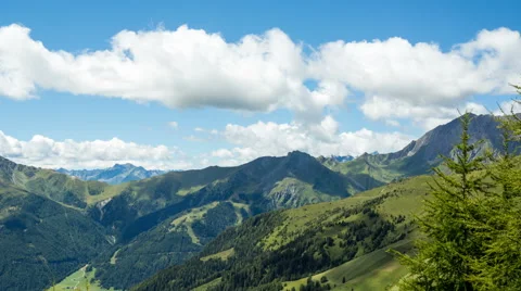 Clouds over alpine mountains paning time lapse Stock Footage 68909360