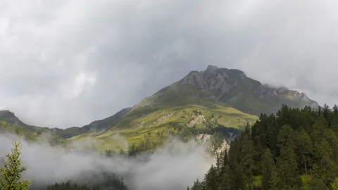 Clouds over alpine mountains time lapse Stock Footage 140896879