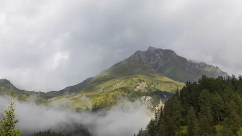 Clouds over alpine mountains time lapse Stockbeeldmateriaal 140897361