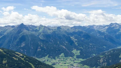 Clouds over alpine valley and mountains time lapse Stock Footage 68908922