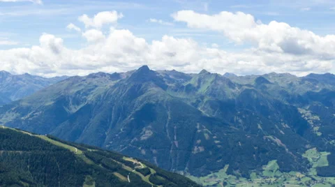 Clouds over alpine valley and mountains paning time lapse Stock Footage 68908945