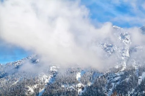 Clouds over alpine winter peaks Stock Photos