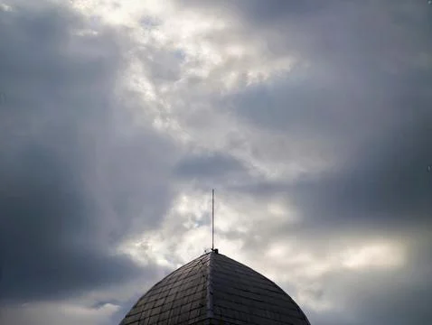 Clouds Over Antenna With Mood. Overcast Sky Features Textured Tiles And Urb.. Photos