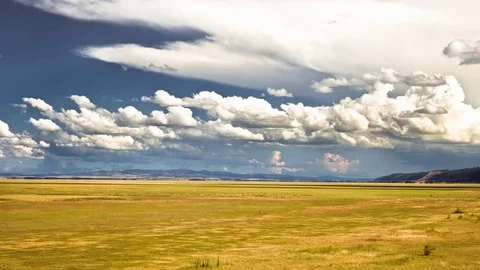 Clouds over beautiful landscape on a sunny day Stock Footage 76100680