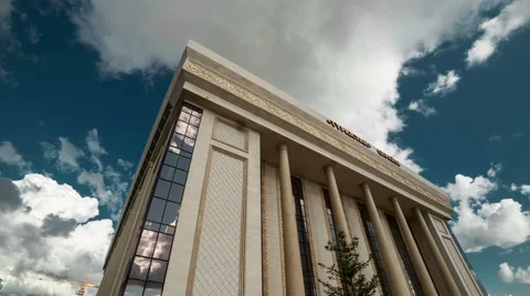 Clouds over the building of the concert hall of the administrative and business Stock Footage 63873975