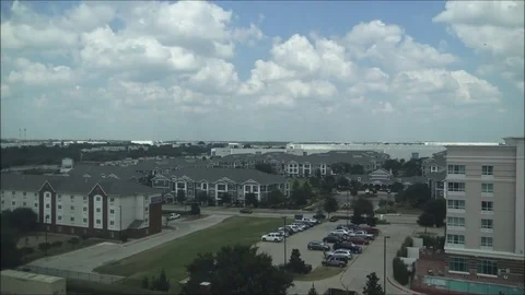 Clouds over commercial buildings timelapse 64x Video stock 80296432