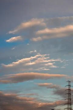 Clouds Over Electric Tower at Sunset Stock Photos