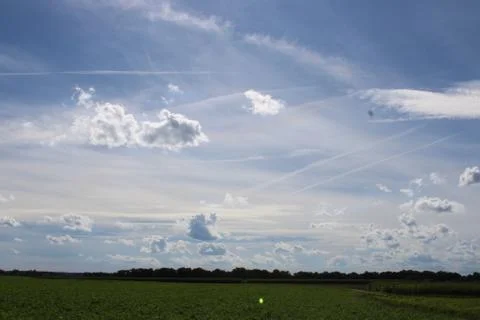 Clouds over field and forest Stock Photos