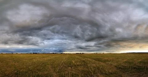 Clouds over the field. Stock Photos