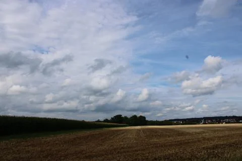 Clouds over a field Stock Photos