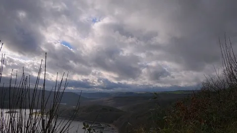 Clouds over forest and lake landscape timelapse Stock Footage 83825427