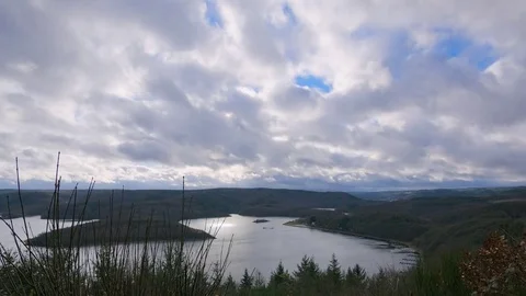 Clouds over forest and lake landscape timelapse Stock Footage 83825623