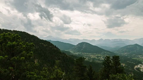Clouds over forested mountains and Estes Park valley timelapse Stock-Footage 154933348