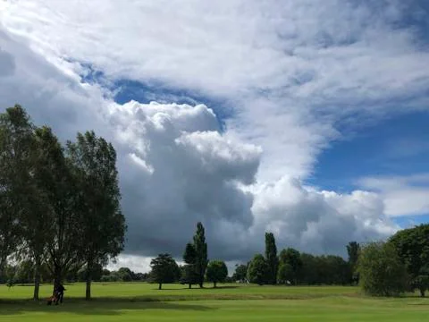 Clouds over golf course fairway Stock Photos
