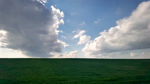 Clouds over a green field Stock Footage 228887208