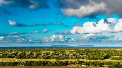 Clouds over the green field, olive trees and sea view in a distance. Timelapse Stock Footage 61767811