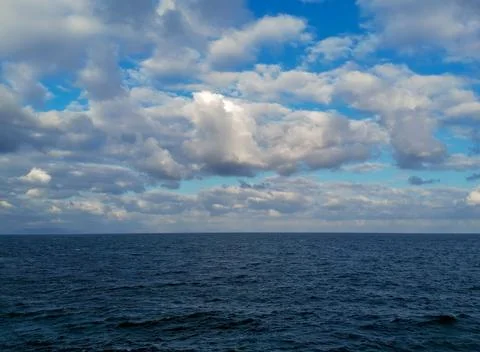 Clouds over the harsh sea 写真素材