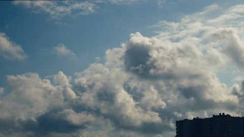 Clouds over the house. Clouds drag the blue sky, trees lean from the wind. Stock Footage 96061320