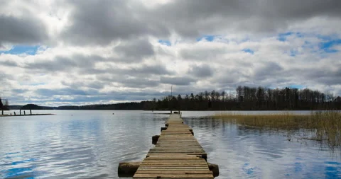 Clouds over the lake and the wooden pier. Stock Footage