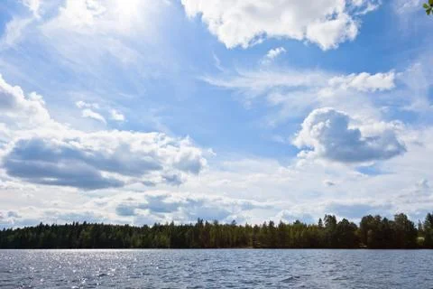 Clouds over a lake Stock Photos