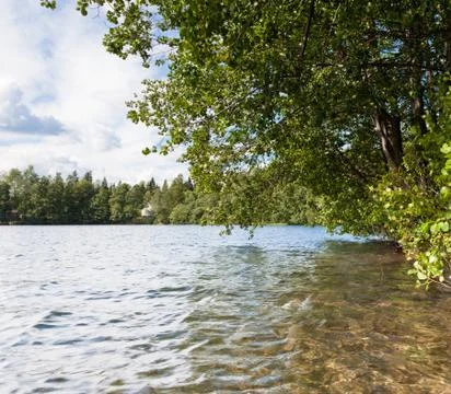 Clouds over a lake Stock Photos