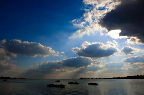 Clouds over the lake Stock Photos