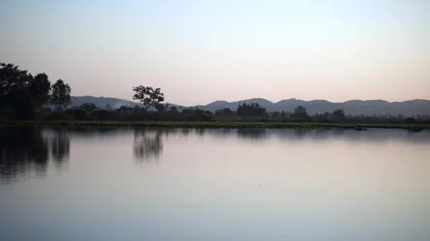 Clouds over lake, a vibrant sunset over a serene lake Stock Footage 260221991