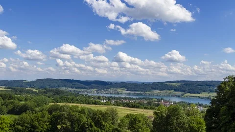 Clouds over landscape with lake Stock Footage 91363365