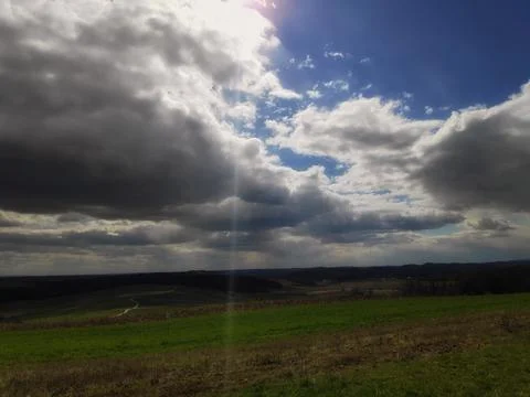 Clouds over Meadow and Valley Stock Photos