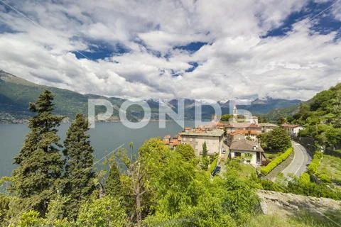 Clouds over the medieval village of Corenno Plinio and Lake Como, Dervio, Lecco Stock Photos